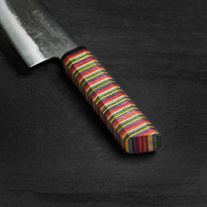 Close up shot of a 180mm Kurouchi Santoku with Skateboard Handle and Ox Horn Ferrule made by Nacionale Bladeworks.